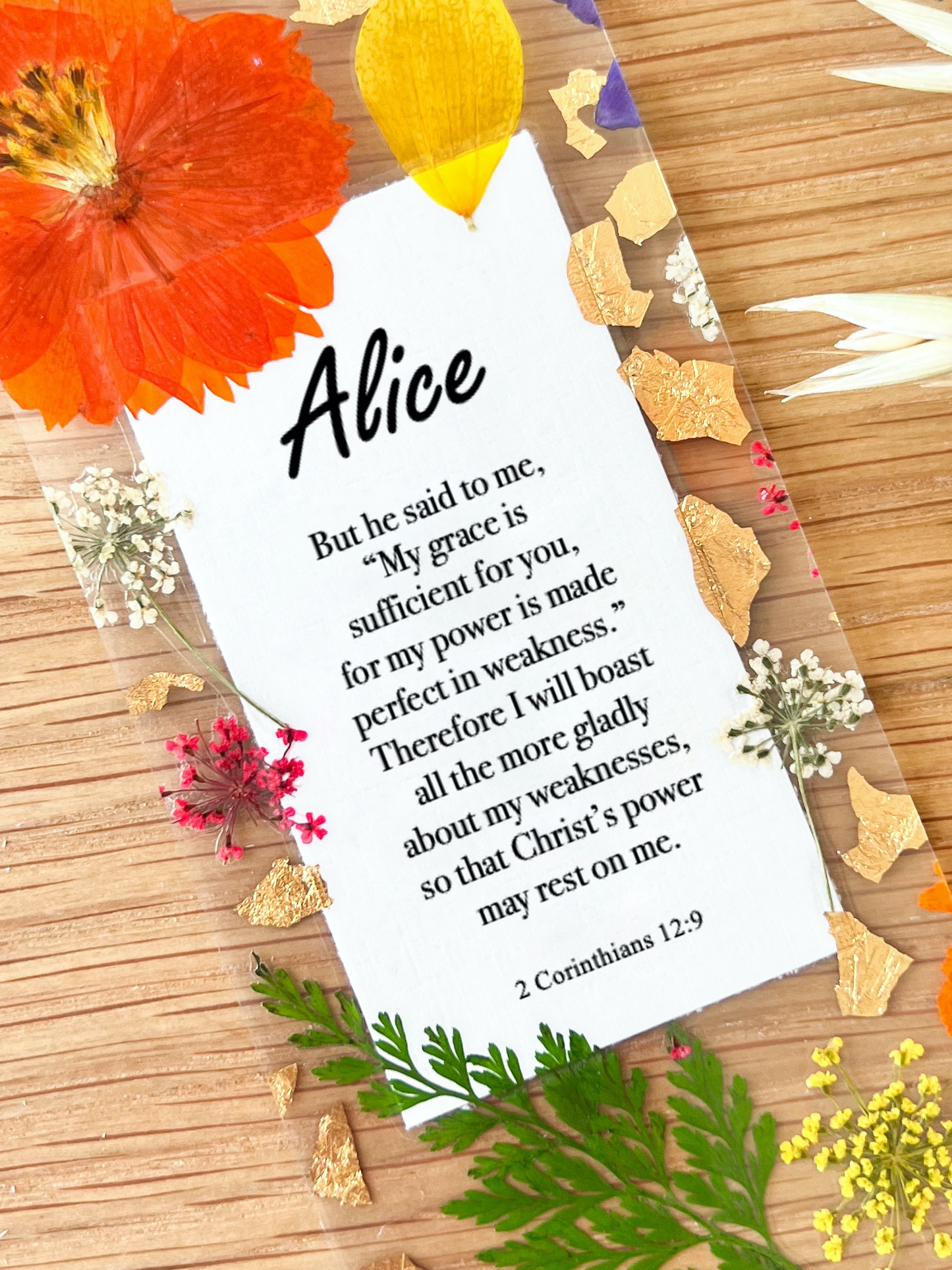  Bookmark includes the following scripture passage : "[custom name] But he said to me, My grace is sufficient for you, for my power is made perfect in weakness. Therefore I will boast all the more gladly about my weaknesses, so that Christ’s power may rest on me."