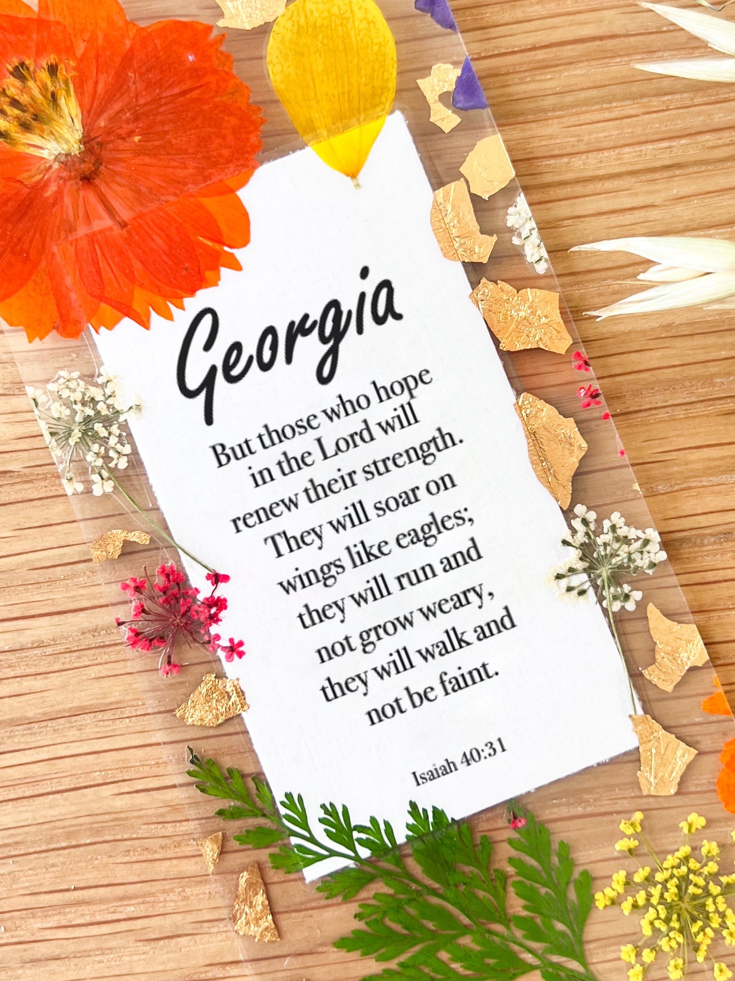  Bookmark includes the following scripture passage : "[custom name] But he said to me, My grace is sufficient for you, for my power is made perfect in weakness. Therefore I will boast all the more gladly about my weaknesses, so that Christ’s power may rest on me. Isaiah 40:31"