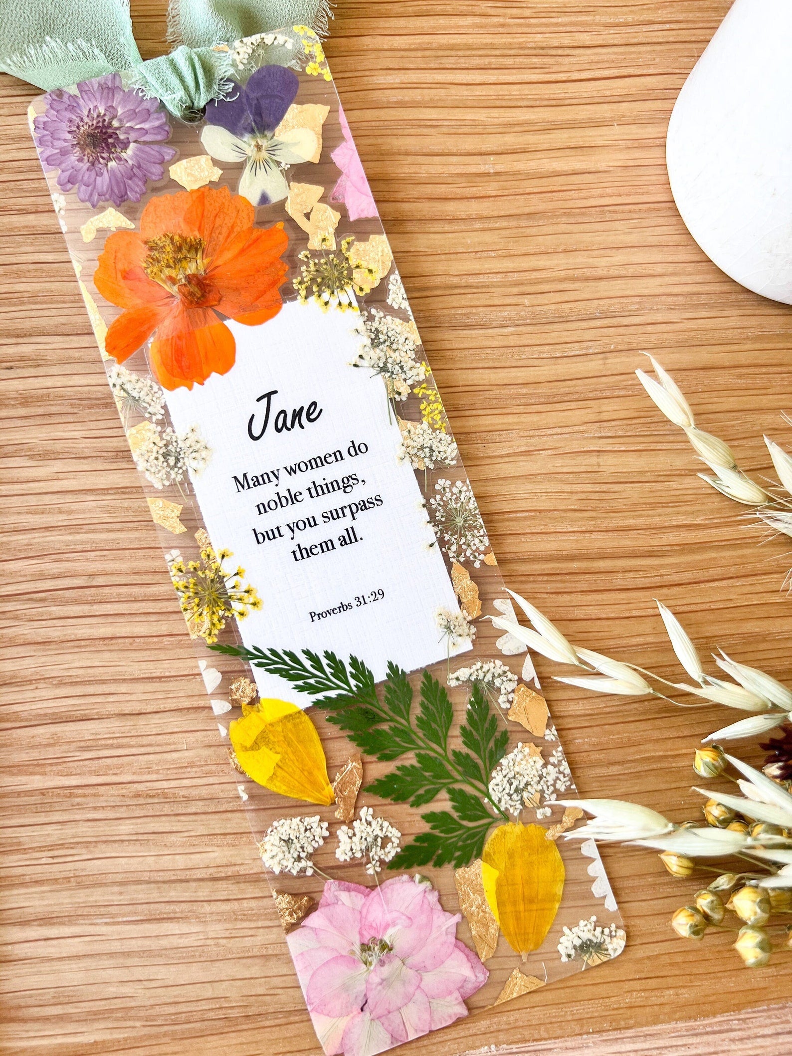  Bookmark includes the following scripture passage : "[custom name] Many women do noble things, but you surpass them all. Proverbs 31:29"