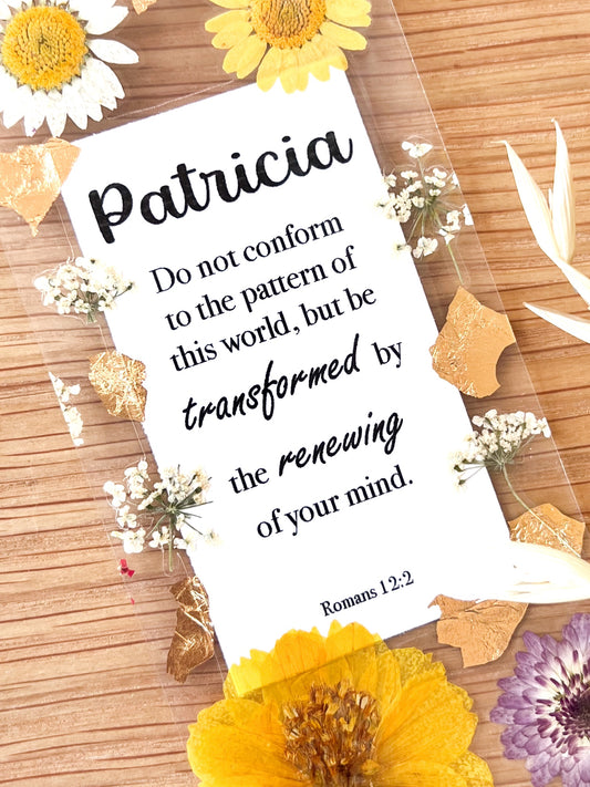 Bookmark includes the following scripture passage : "[custom name] Do not conform to the pattern of this world, but be transformed by the renewing of your mind. Romans 12:2"