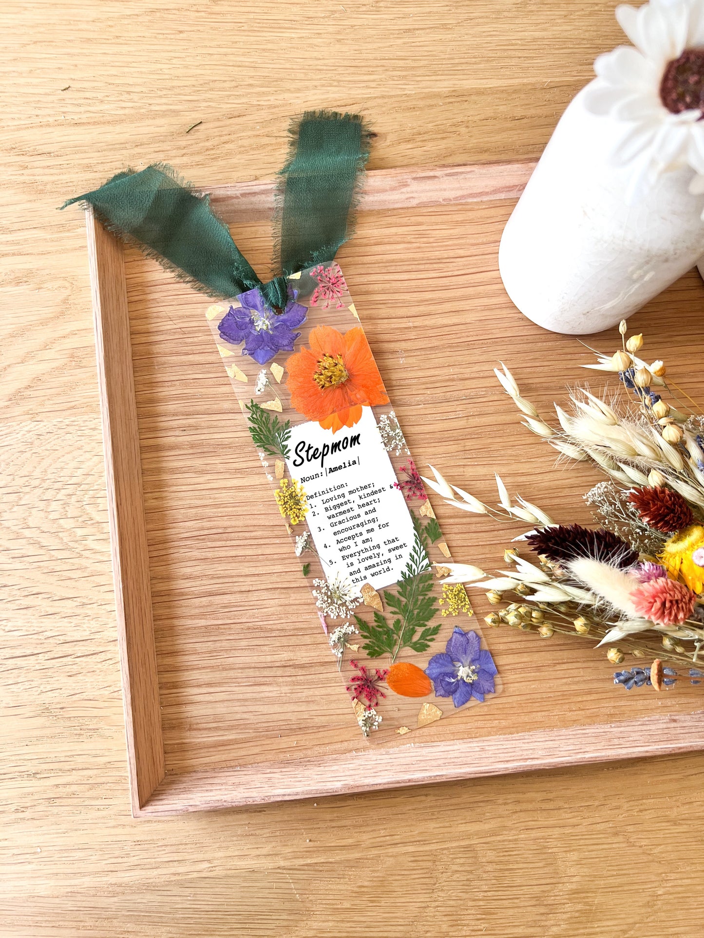 Pressed flower bookmark with the following quote "Stepmom  Noun:|Name|  Definition: 1.	Loving mother; 2.	Biggest, kindest  & warmest heart; 3.	Gracious and encouraging; 4.	Accepts me for  who I am; 5.	Everything that  is lovely, sweet and amazing in this world."