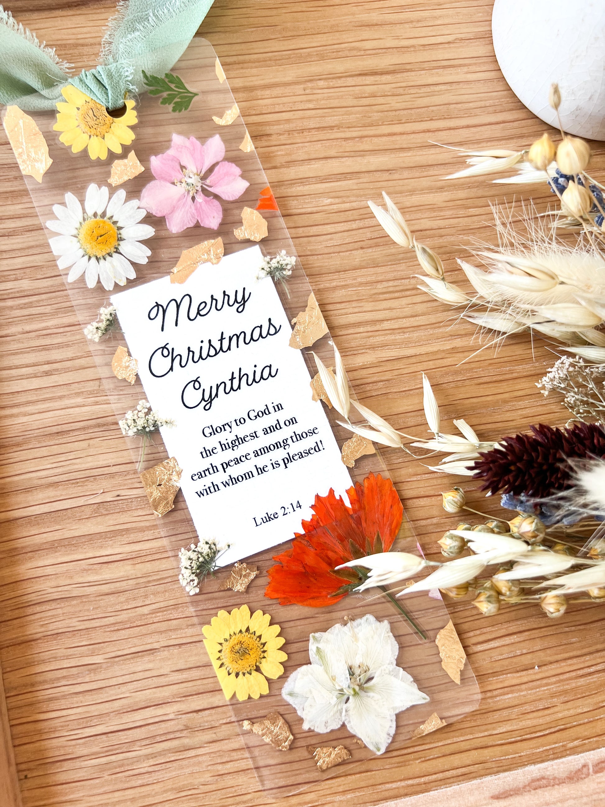  Bookmark includes the following scripture passage : "Merry Christmas [custom name] Glory to God in the highest and on earth peace among those with whom he is pleased! Luke 2:14