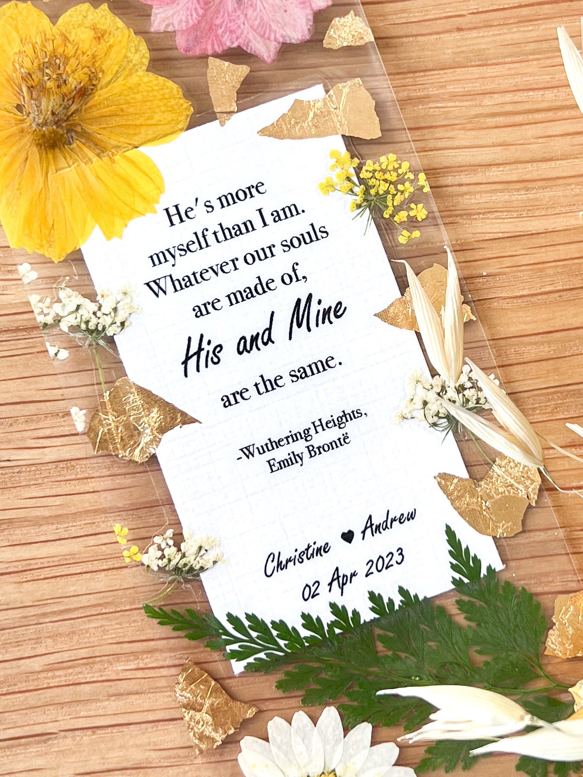 Bookmark includes the following romantic quote by Emily Brontë (Wuthering Heights): "He's more myself than I am. Whatever our souls are made of, his and mine are the same. [custom names][custom dates]"